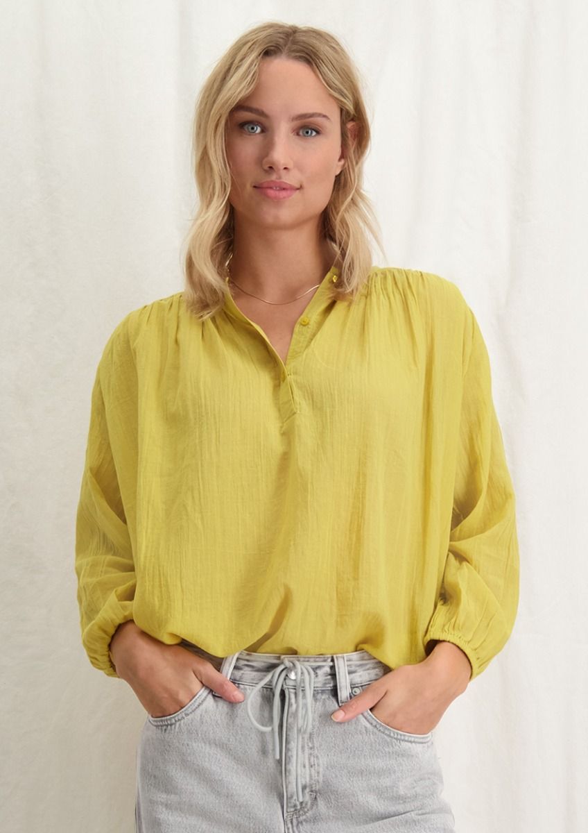 Gele top sale dames